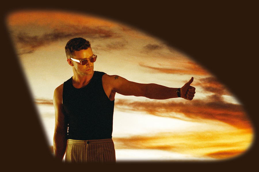 A poster featuring Justin Timberlake wearing sunglasses and a black sleeveless shirt, giving a thumbs-up against a sunset background. The image has a stylized, vignette border.