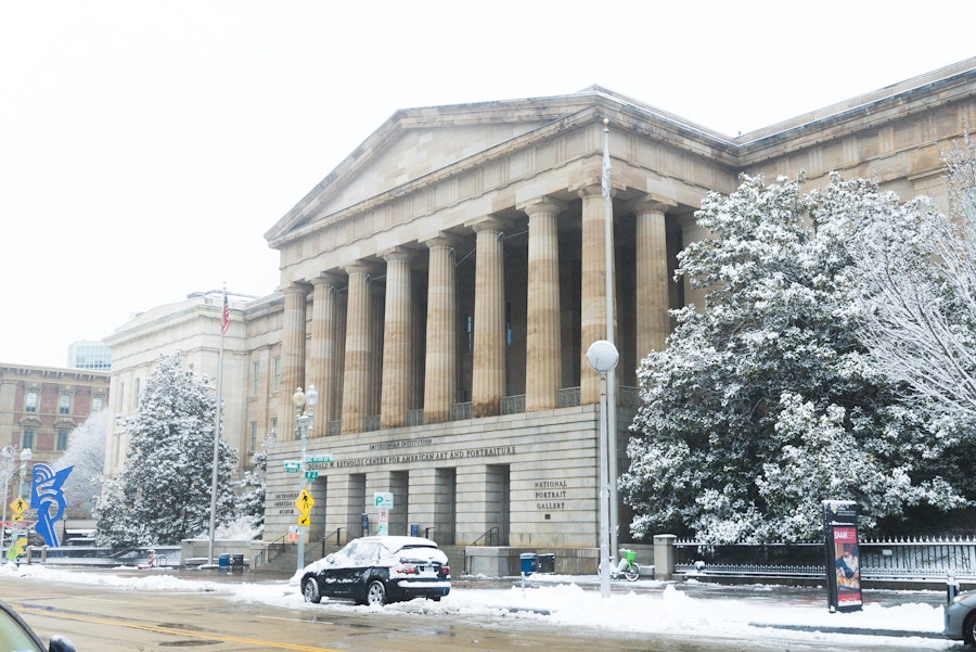 The National Portrait Gallery's grand facade dusted with a layer of fresh snow in Washington, DC.