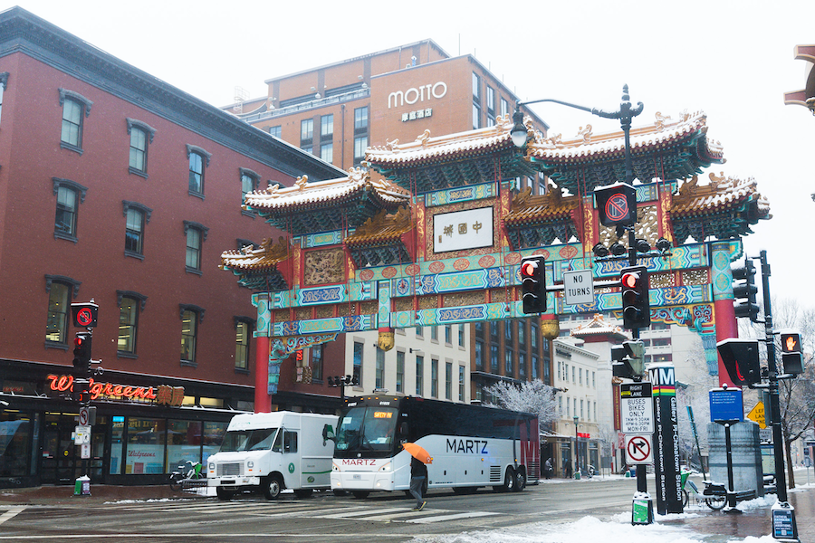 The iconic Chinatown Friendship Archway in Washington, DC, surrounded by snow-covered streets.