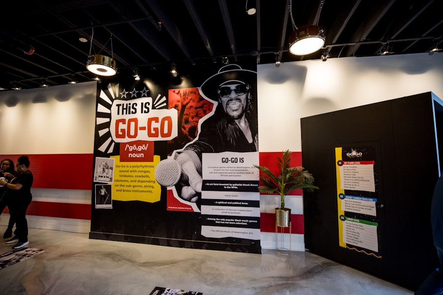 A wall exhibit titled "This Is Go-Go" explains the history and significance of the music genre, with a large portrait of Chuck Brown.