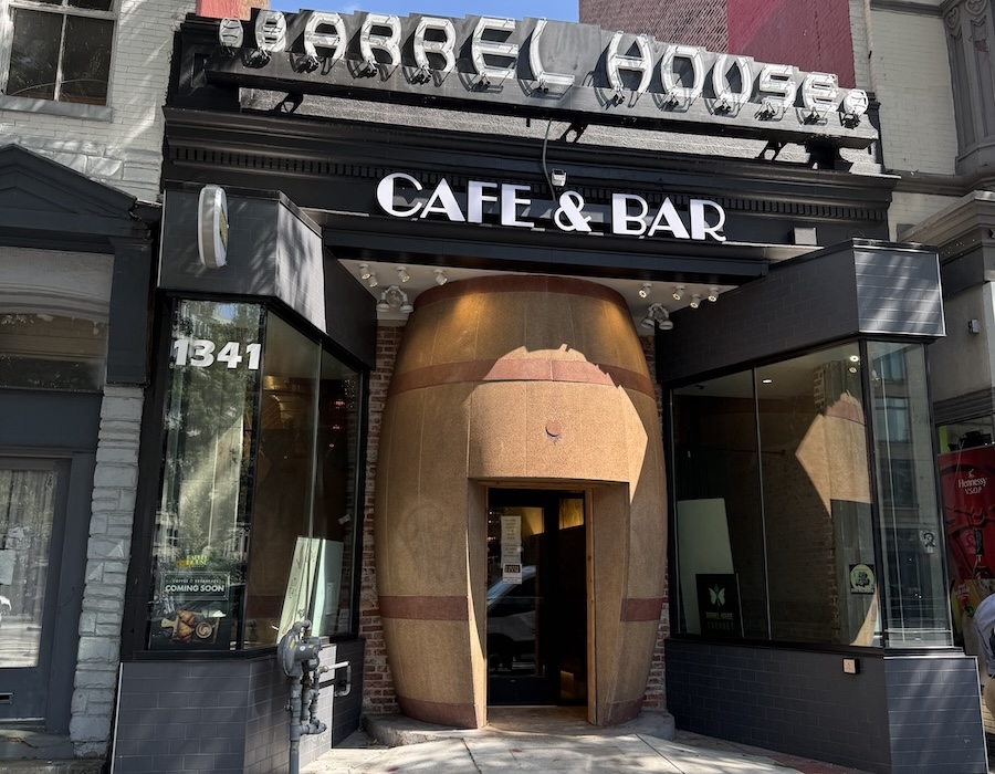 Street view of Barrel House Cafe & Bar in Washington, DC, featuring its barrel-shaped entrance beneath a vintage neon sign.