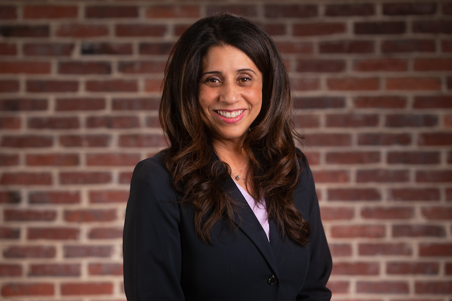 A woman smiles for a professional headshot. 