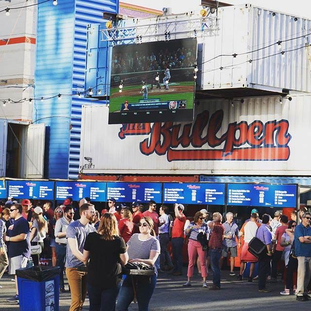 @thebullpendc - Fans watching baseball at The Bullpen outside of Washington Nationals Park in DC's Navy Yard neighborhood