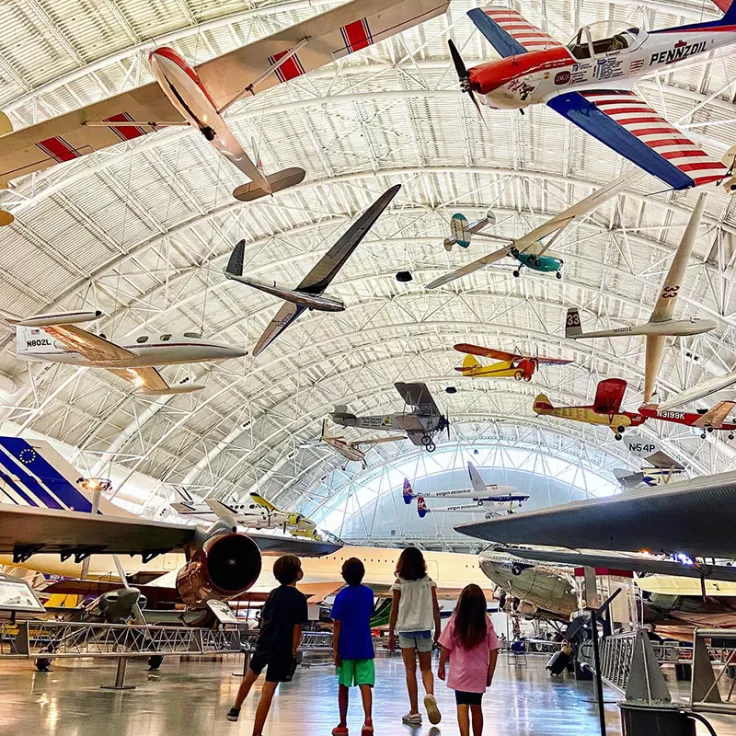 Kids looking up at airplanes at Smithsonian National Air &amp; Space Museum Udvar Hazy