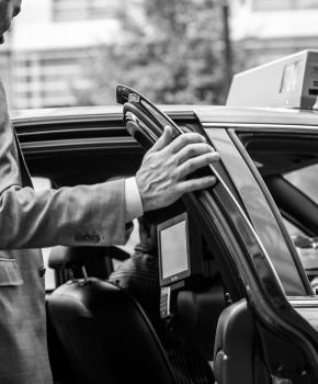 man getting inside a DC taxi cab