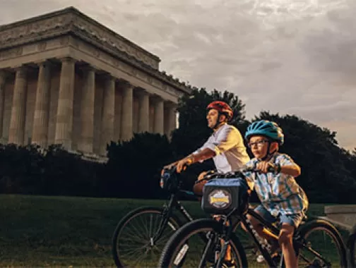 Family biking in front of Lincoln Memorial