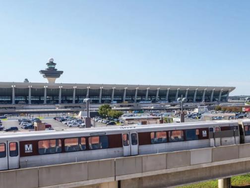 Dulles International Airport with two Metro cars running in front of it.